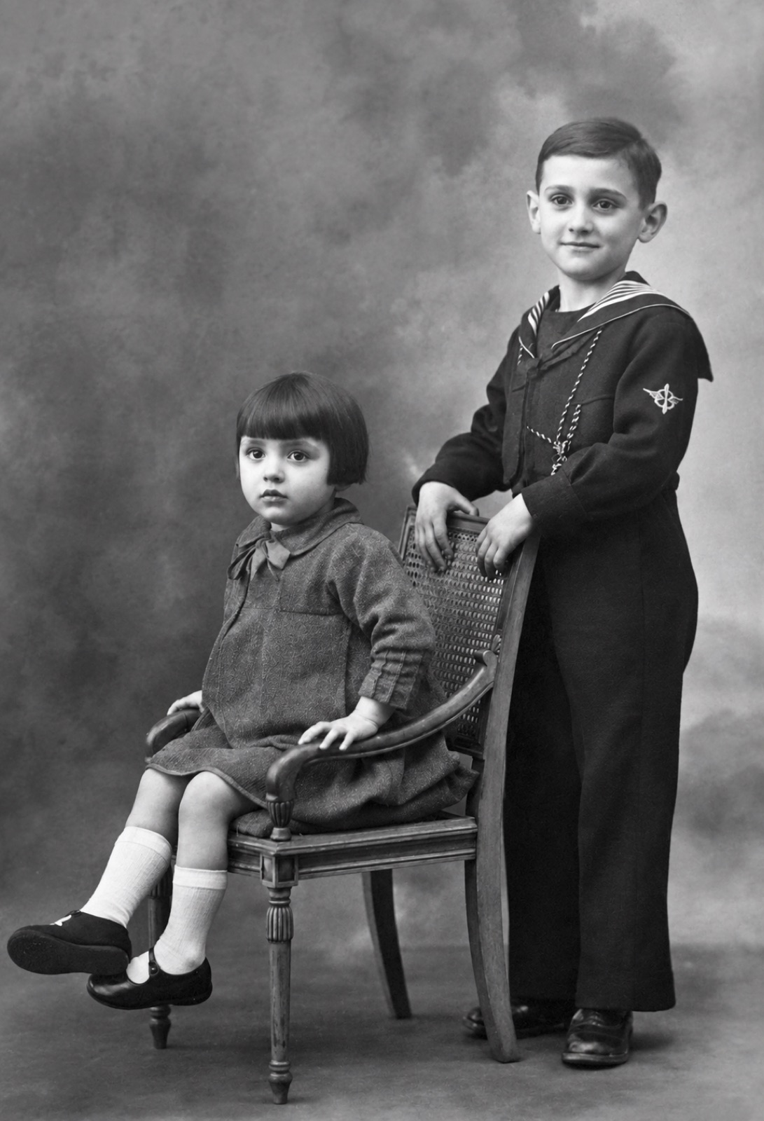 Restored studio portrait of two children, before and after restoration